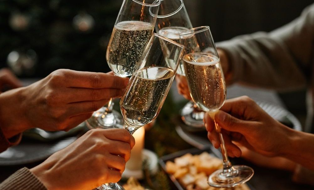 4 hands toast Champagne glasses