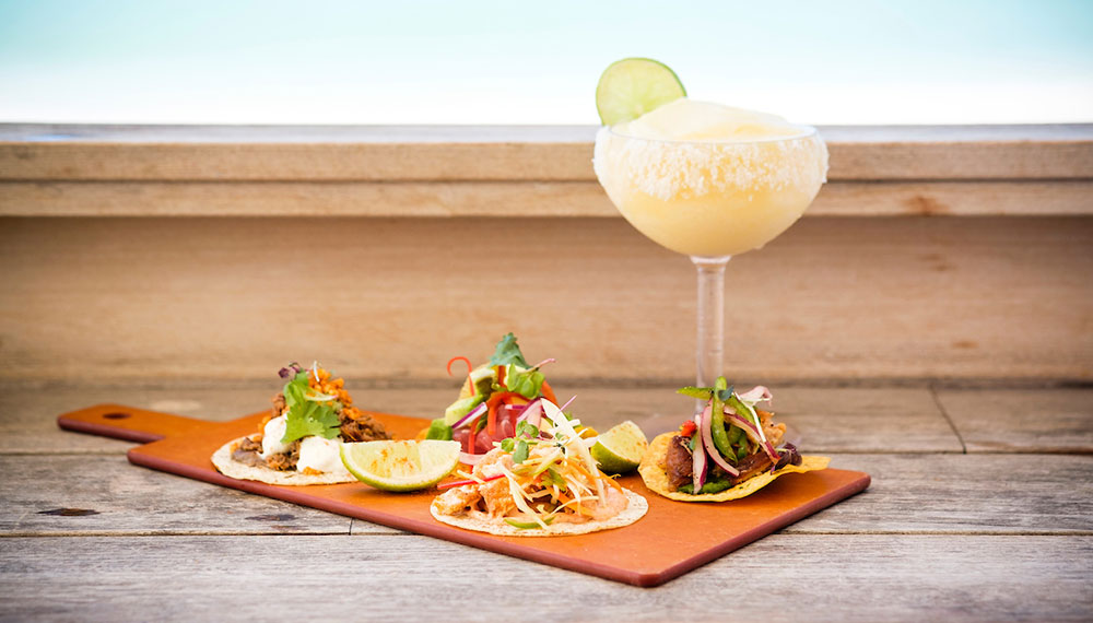 frozen tequila cocktail and tacos on a serving platter at our Coccoloba restaurant