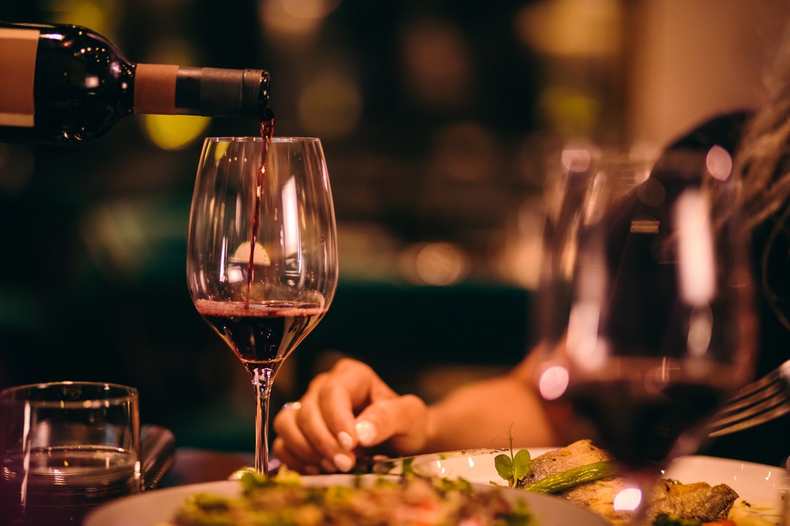 red wine pour at dinner table