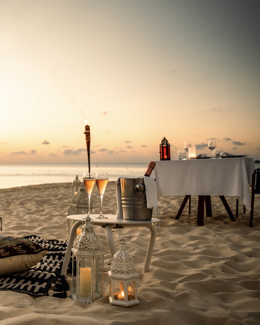 fancy dinner set up on the beach at Kimpton Seafire