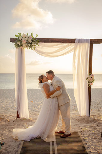 newlyweds kiss at beach ceremony location at Kimpton seafire